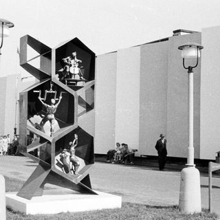 Sculpture depicting athletes displayed at an outdoor exhibition.