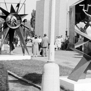 Sculpture depicting athletes displayed at an outdoor exhibition.