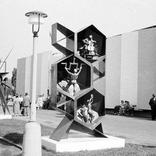 Sculpture depicting athletes displayed at an outdoor exhibition.