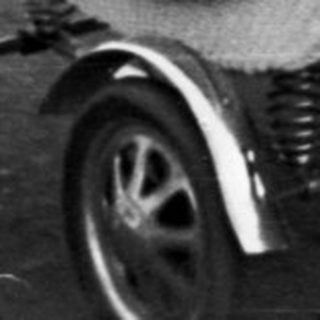 Woman and child near a vintage wicker baby carriage.