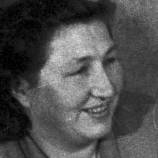 Black and white photo of a couple indoors, smiling.