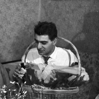 Black and white photo of a couple indoors, smiling.