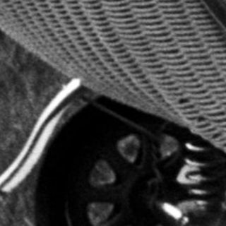 Black and white image of a baby in a vintage pram.