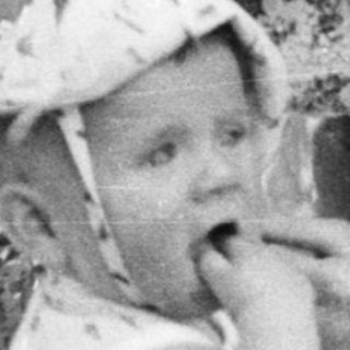 Black and white photo of a woman and child outdoors.