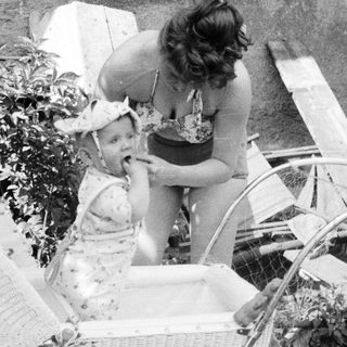 Black and white photo of a woman and child outdoors.