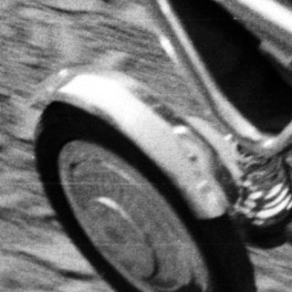 Baby in a vintage stroller, monochrome photograph.