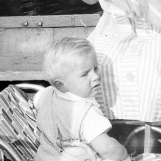 Black and white photo of a woman and child in a boat.