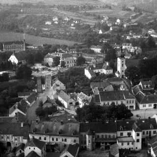 Aerial view of a town with a church tower.