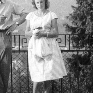 Three people standing outdoors, possibly overlooking a landscape.