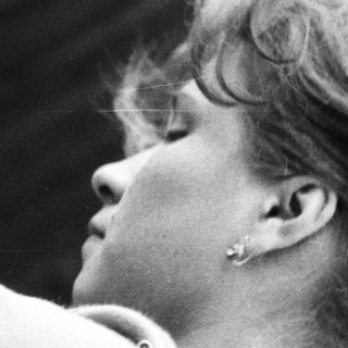 Black and white portrait of a woman with short hair.