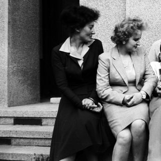Group of people seated together, appearing joyous and celebratory.