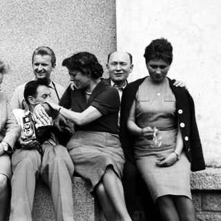 Group of people seated together, appearing joyous and celebratory.