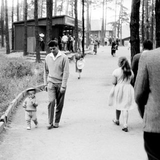 A man walks with a child along a path.