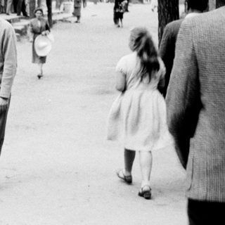 A man walks with a child along a path.