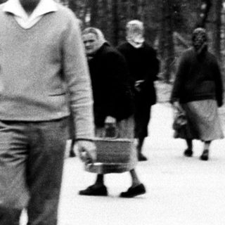 Man walking down a path with a child and others.