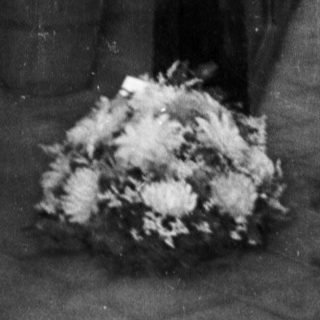 Black and white image of a funeral or memorial service.