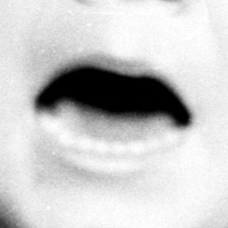 Black and white image of a child with an open mouth.