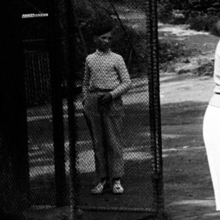 Woman and toddler walk outdoors; others are in background.
