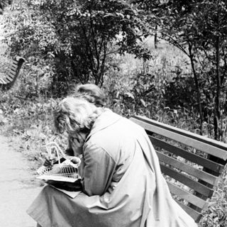 Couple with child strolls along a path in a park.