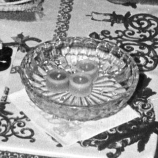 Table setting with plates, silverware, and a decorative centerpiece.