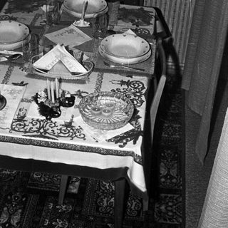 Table setting with plates, silverware, and a decorative centerpiece.