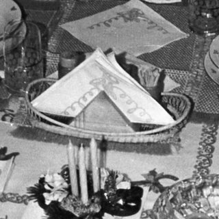 Table setting with plates, silverware, and a decorative centerpiece.