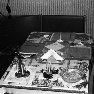 Black and white photo of a decorated table setting.