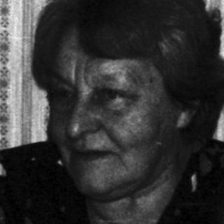 Boy with cake and older woman, possibly celebrating a birthday.