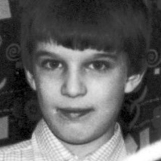 Boy holding toy car, likely a Christmas photo.