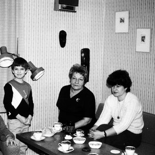 Black and white photo of three people at a table.