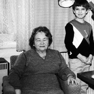 Black and white photo of three people at a table.