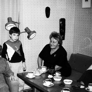 Black and white image of a family gathered indoors.