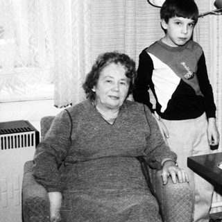 Black and white image of a family gathered indoors.