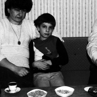 Black and white photo of a family at a table.