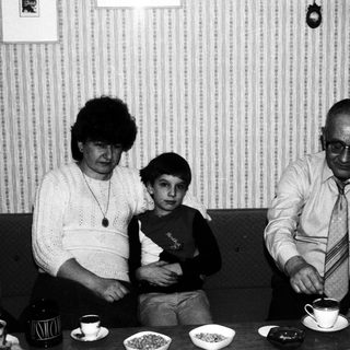 Black and white photo of a family at a table.