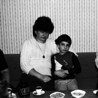 Black and white photo of a family at a table.