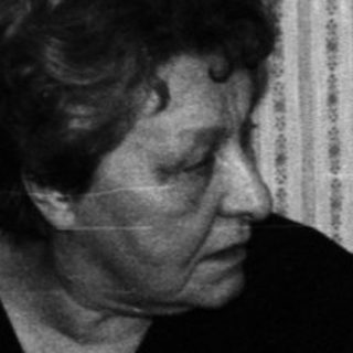 Three people sitting and conversing in a room.