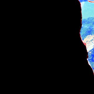 Silhouette overlooking a mountainous, forested landscape with a river.