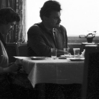 Pair seated at a table in a restaurant setting.
