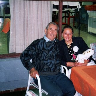 Couple sits at table in a restaurant or bar.