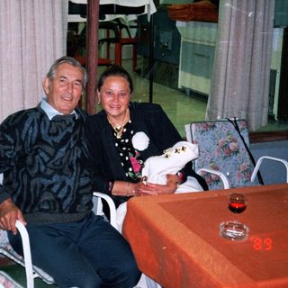 Couple sits at table in a restaurant or bar.