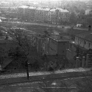 Here's a brief summary of the image: Row of houses viewed from a slightly elevated perspective.