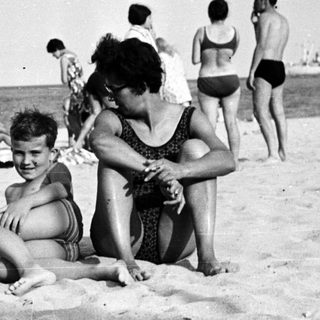 Black and white photo of people on a beach.
