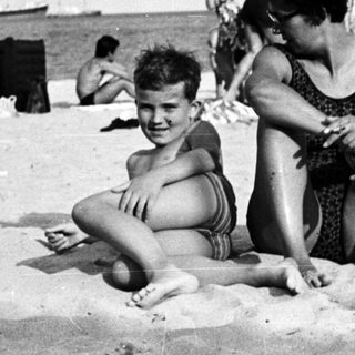 Black and white photo of people on a beach.