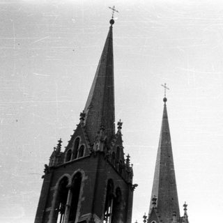 Two tall, pointed church spires reach into the sky.