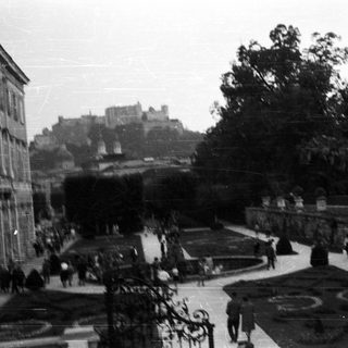 Formal gardens with a castle visible in the distance.