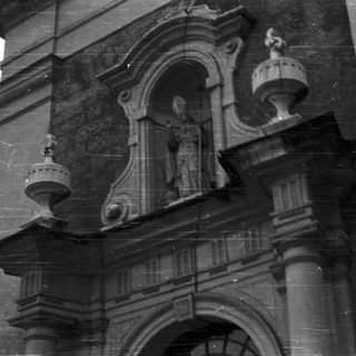 Black and white photo depicts a stone architectural facade.