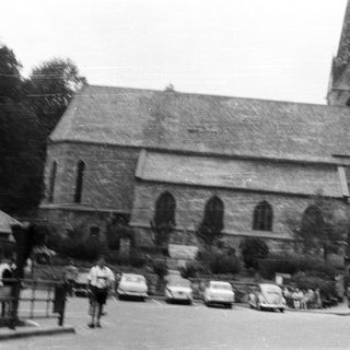 Black and white photo of a stone church and street.