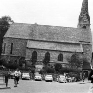 Black and white photo of a stone church and street.