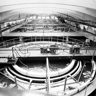 Circular water tank with platforms and overhead infrastructure.